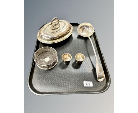 A small group of silver-plate comprising a lidded entrée dish, a ladle, a bottle coaster and two tots. (One tray) 
