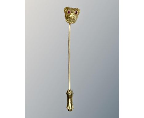 A 14ct yellow gold stick pin modelled as a pug's head set with ruby eyes, length 60 mm, 2.4g.