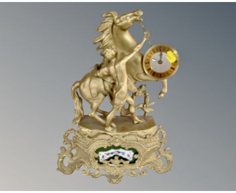 A Shatz gilt figural mantel clock depicting a man with stallion. (height 40cm)