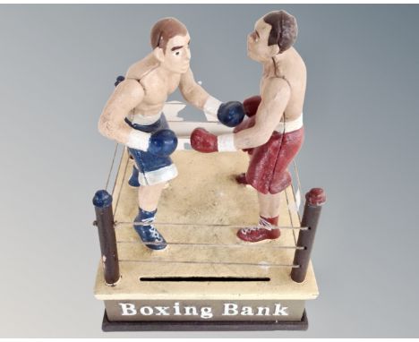 A cast iron novelty boxing money bank.