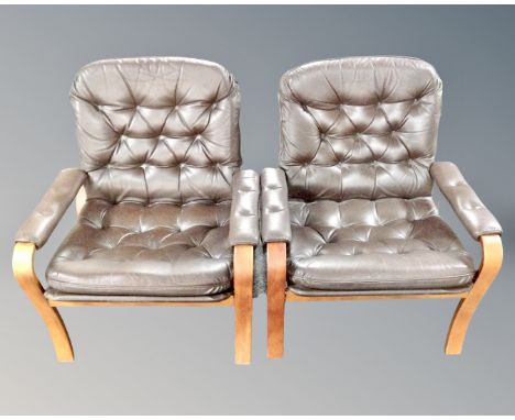 A pair of Scandinavian bentwood armchairs upholstered in brown button leather.