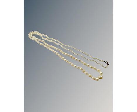 An early 20th century graduated pearl necklace, on 9ct yellow gold clasp, length 95 cm.