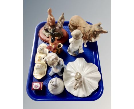 A tray containing Nao figures, Crown Ducal china cruet, Lladro hand bell etc.