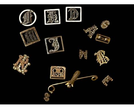 Collection of eleven vintage gold, silver and enamel initial buckles and part bar brooch.