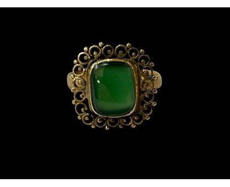 Green jade and gold ring with filigree border, size P.