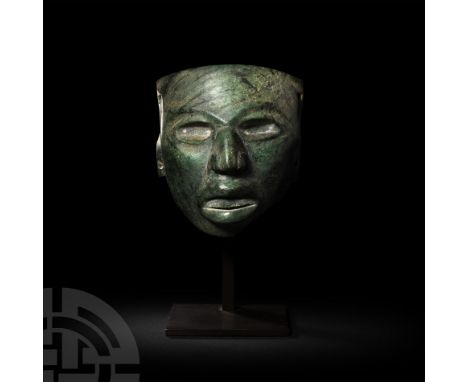 6th-9th century A.D. A human mask carved from a block of jade with lateral piercings for attachment at the temple and lower e