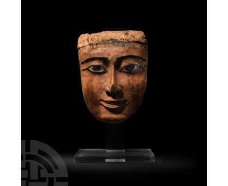 Late New Kingdom, 1350-1070 B.C. A wooden funerary mask with finely delineated painted eyes and eyebrows on a gesso ground; h
