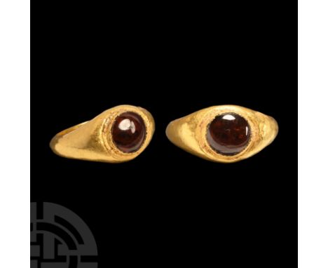1st century A.D. A hollow-formed gold finger ring with inset cabochon garnet. Cf. Chadour, A.B., Rings. The Alice and Louis K