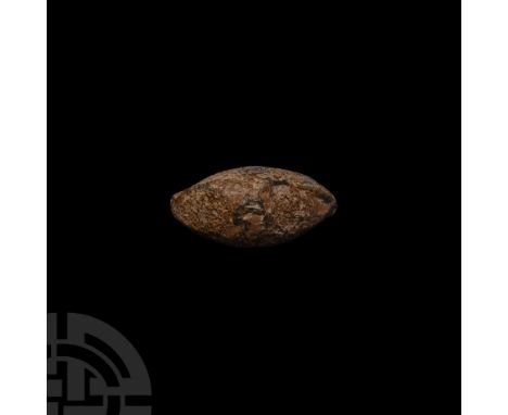 45 B.C. A biconical facetted lentoid-section lead sling shot (glans), inscription monogram a combination of letters 'C', 'A' 