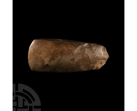 Dolman Period, 3700-3300 B.C. A finely knapped and polished axe with convex cutting edge and square sides in a grey chert; ev