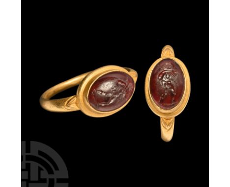 1st-3rd century A.D. A garnet cabochon with intaglio satyr traveller advancing with staff and pouch over his shoulder, set in