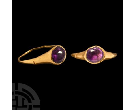 Circa 2nd-3rd century A.D. A slender gold finger ring with ellipsoid cell and inset cabochon amethyst. Cf. Ruseva-Slokoska, L
