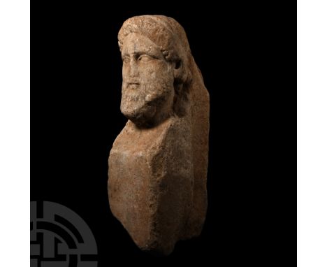 Circa 1st century B.C. A carved marble herm boundary marker carved in the round as the bust of an adult male wearing a conica