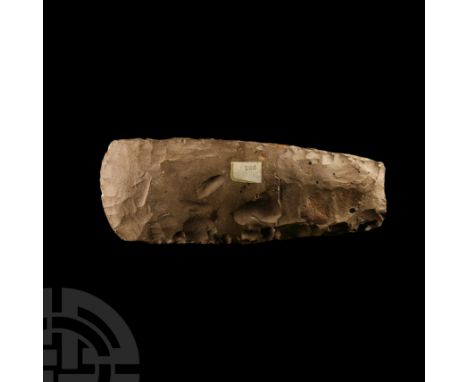 Dolman Period, 3700-3300 B.C. A deeply knapped and part polished axe with square sides and convex cutting edge, this edge wit