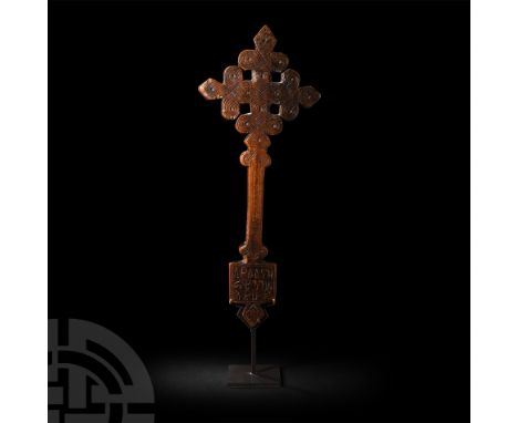 17th-18th century A.D. A bifacial wooden cross comprising intertwined elements with trefoil finials, resting on a tall stem d