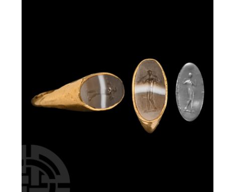 2nd-1st century B.C. A hollow-formed gold finger ring with inset sardonyx intaglio of Venus (Aphrodite) standing nude dressin