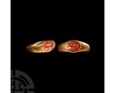 2nd century A.D. A solid, smooth gold ring with D-shaped hoop, oval carnelian intaglio with a bull surmounted by a star; repa