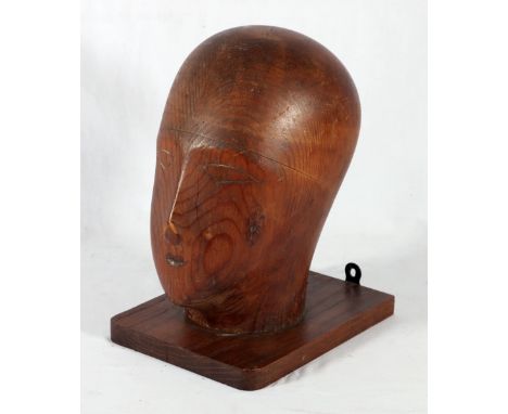 Milliner's head dummy mounted on wall bracket, 28cm.   CONDITION REPORT:  Small splits to the top of head, scuffed and scratc