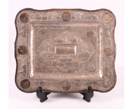 Indian silver card tray with relief and punched decoration depicting village scenes, lobed rectangular shape, 24cm x 19.5cm.