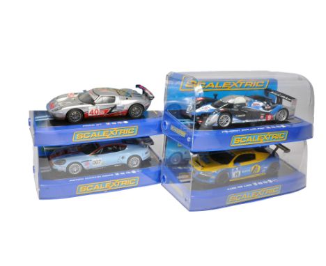 Scalextric slot car issues comprising Audi R8 LMS, Peugeot 908 Hdi FAP, Aston Martin DBR9 plus Ford GT. All appear to be with