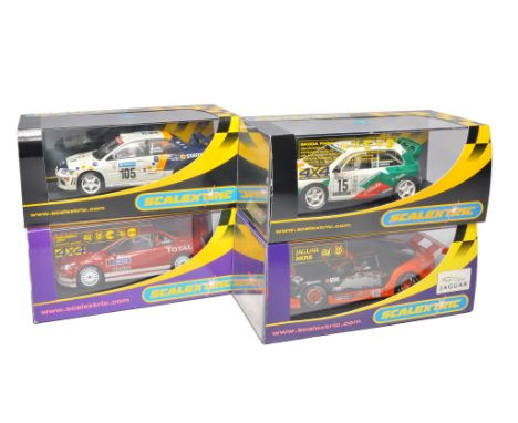 Scalextric slot car issues comprising Skoda Fabia WRC, Mitsubishi Lancer Evolution VII WRC, Peugeot 307 WRC plus Jaguar XKRS.