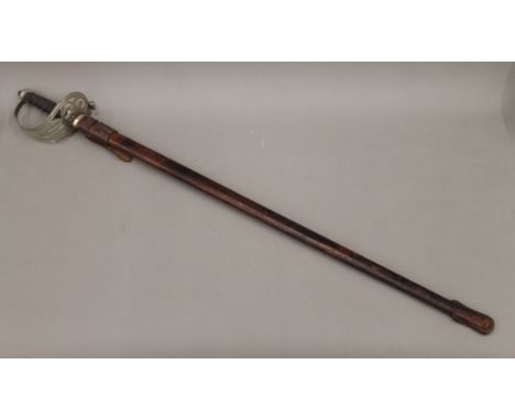 A George V Service sword in scabbard. 99 cm long.