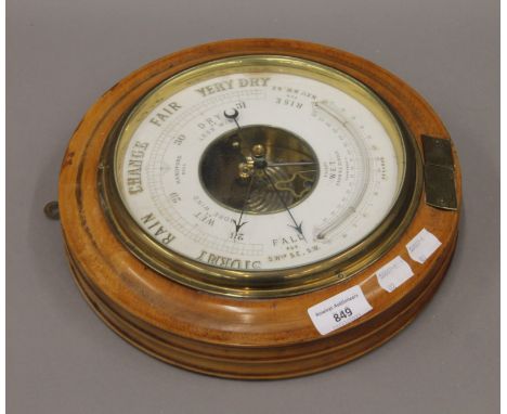 A Victorian oak framed barometer. 28 cm diameter.