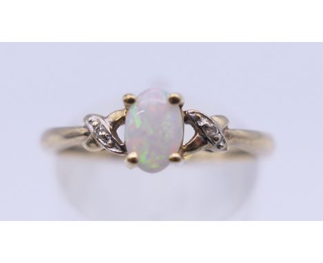 A 10 K gold opal and diamond ring. Ring size N/O. 1.4 grammes total weight.