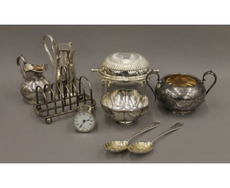 A small quantity of silver plate and a small alarm clock. 