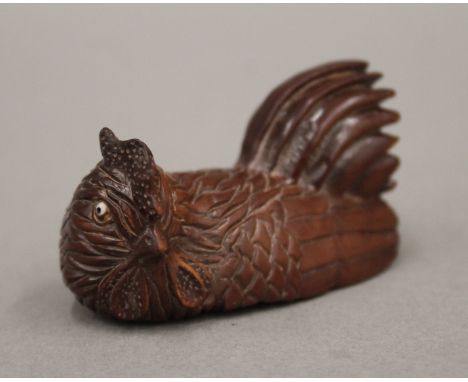 A signed netsuke formed as a chicken. 5.5 cm long.
