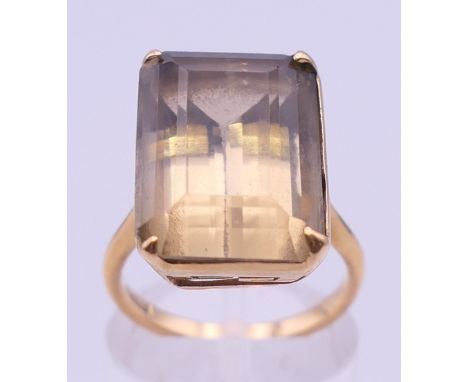 An 18 ct gold smoky quartz ring.  Quart 1.75 x 1.25 cm. Ring size J/K. 7.1 grammes total weight.