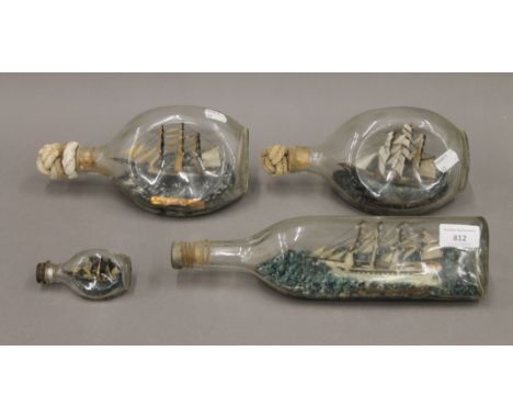 Four vintage ship in bottle models. The largest 30.5 cm long.
