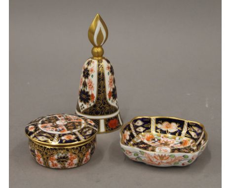 A Royal Crown Derby candle snuffer, a trinket box and a small dish. The former 12 cm high.
