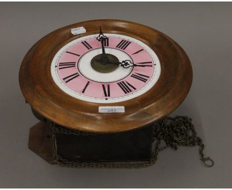 A Victorian postman's alarm clock with pink dial. 28 cm diameter.