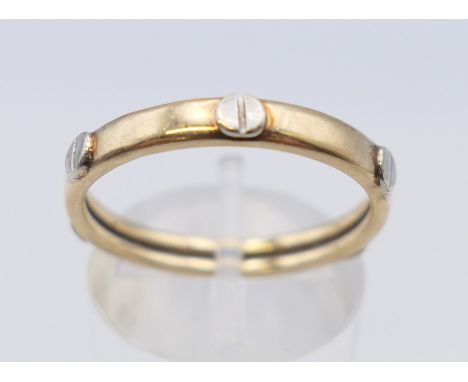 A Cartier style 9 ct white and yellow gold screw ring. Ring size R. 1.4 grammes,