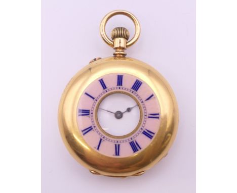 An 18 K gold enamelled half hunter timepiece, stamped to interior, in working order.  3.75 cm diameter. 49.9 grammes total we