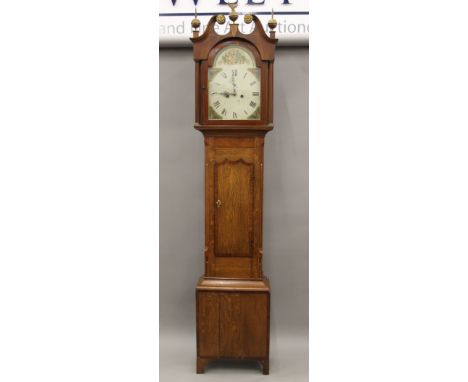 A 19th century oak and mahogany eight-day longcase clock with painted dial. Approximately 225 cm high.