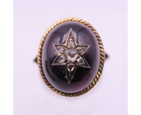 A Victorian unmarked 18 ct gold diamond set cabochon garnet ring. Ring size J/K. 7.4 grammes total weight.