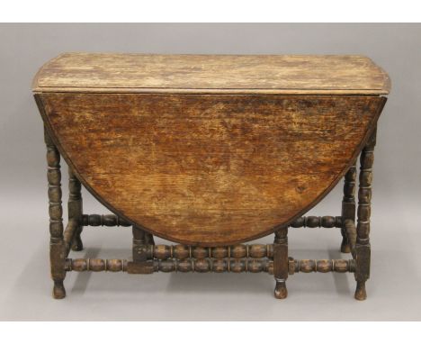 A large oak gate leg table. 113 cm long.