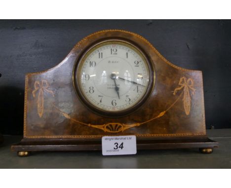 An Edwardian burr walnut and inlaid eight day mantel clock bearing retailers mark T T Cooper Earlstown.