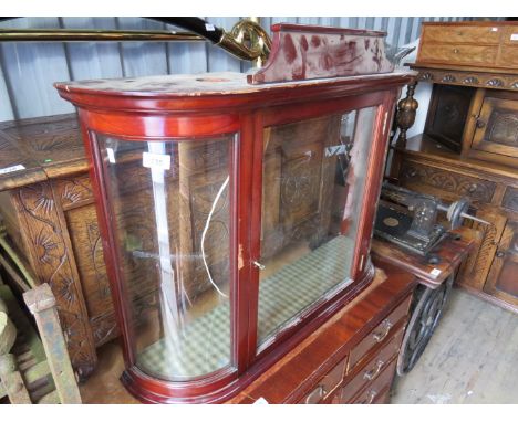 A small bow front glazed counter display cabinet with integral light 