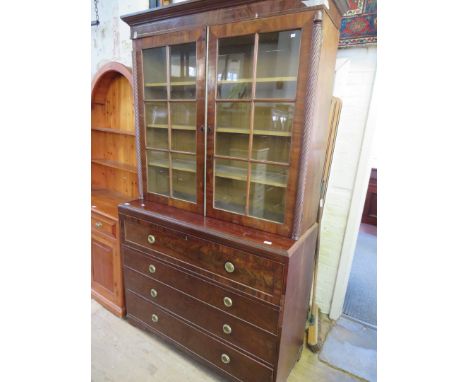 A George III mahogany secretaire bookcase cabinet, the top section with moulded cornice with brass inlay, over two glazed doo