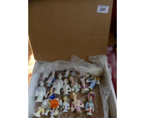 A collection of various ceramic pin cushion dolls