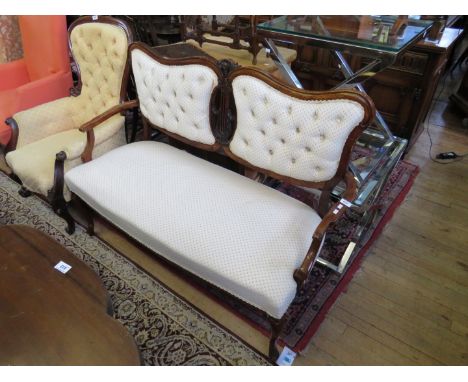 An Edwardian sofa with carved show wood frame, upholstered in buttoned fabric. CONDITION REPORT: 55cm 