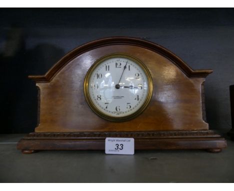 An Edwardian mahogany cased mantel clock bearing retailers mark for Lloyd Payne & Amiel Manchester.