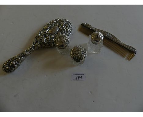 A silver dressing table set to include mirror, comb and three glass pots 