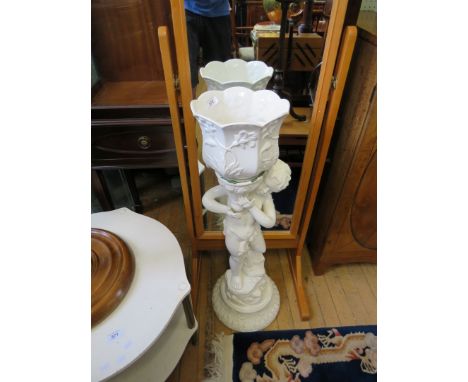 A modern white ceramic figural jardiniere and stand 