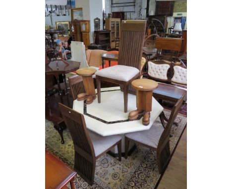 A contemporary marble effect dining table of octagonal form, having four splat back chairs with grey upholstered seats.