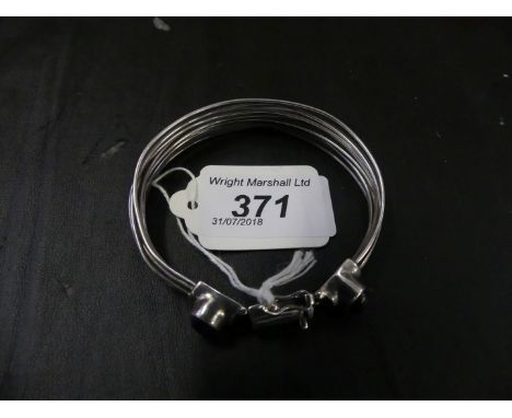 A bangle with amethyst cabochon clasp, stamped 925, weight approx 35.1g