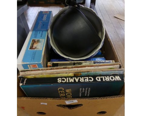 A mixed lot of assorted books, jigsaw puzzle, riding helmet and a blue and white jardiniere.